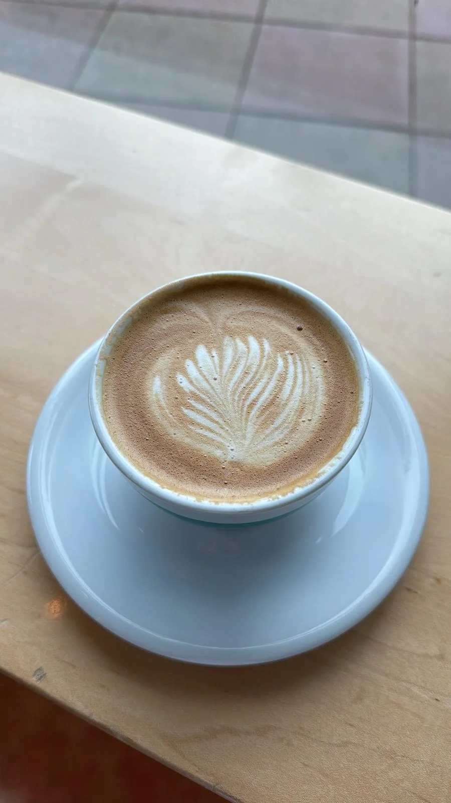 Joseph Chamdani at a coffee shop — latte and iced americano are go-to orders
