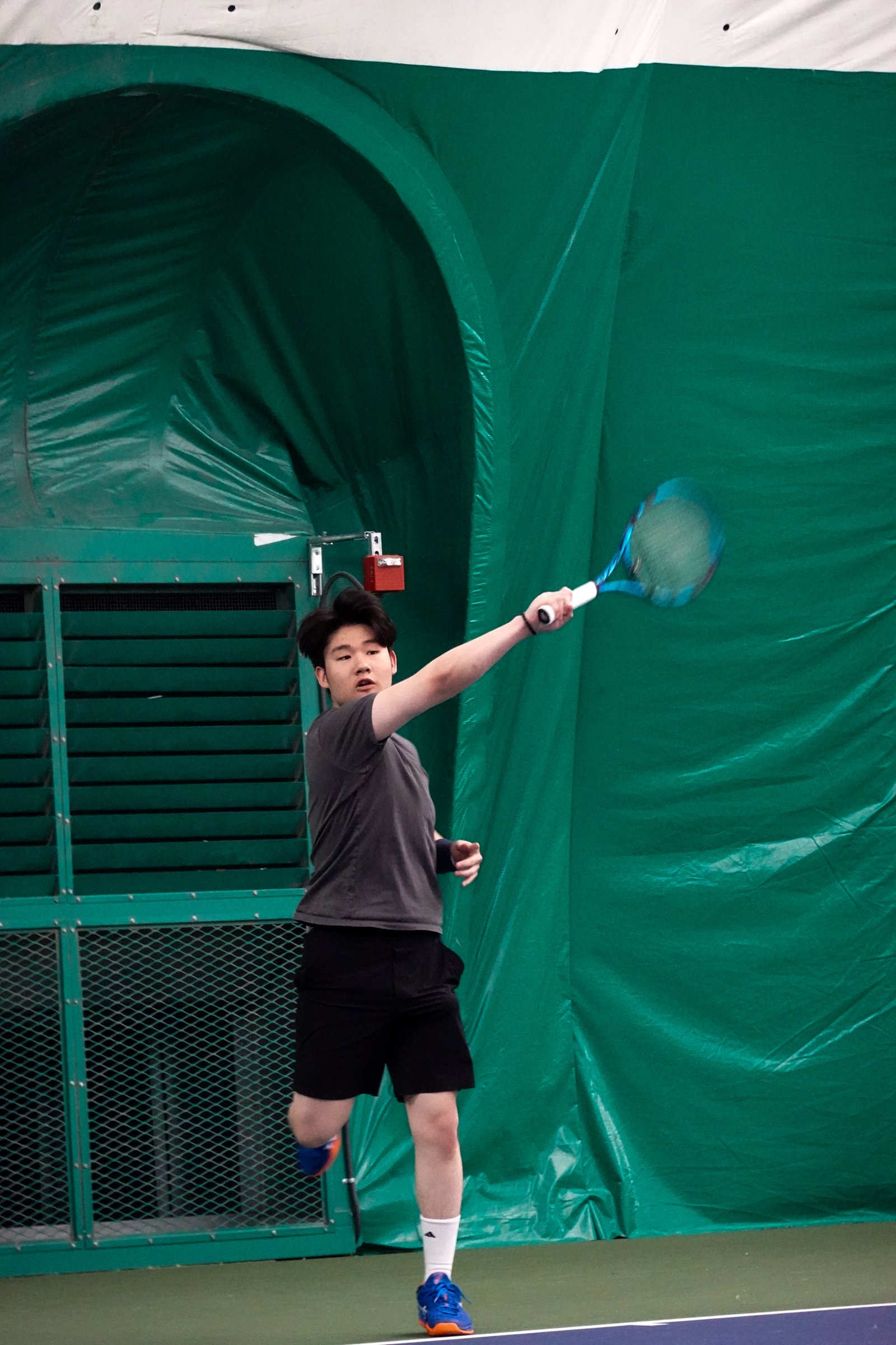 Joseph Chamdani playing tennis — forehand shot on the court