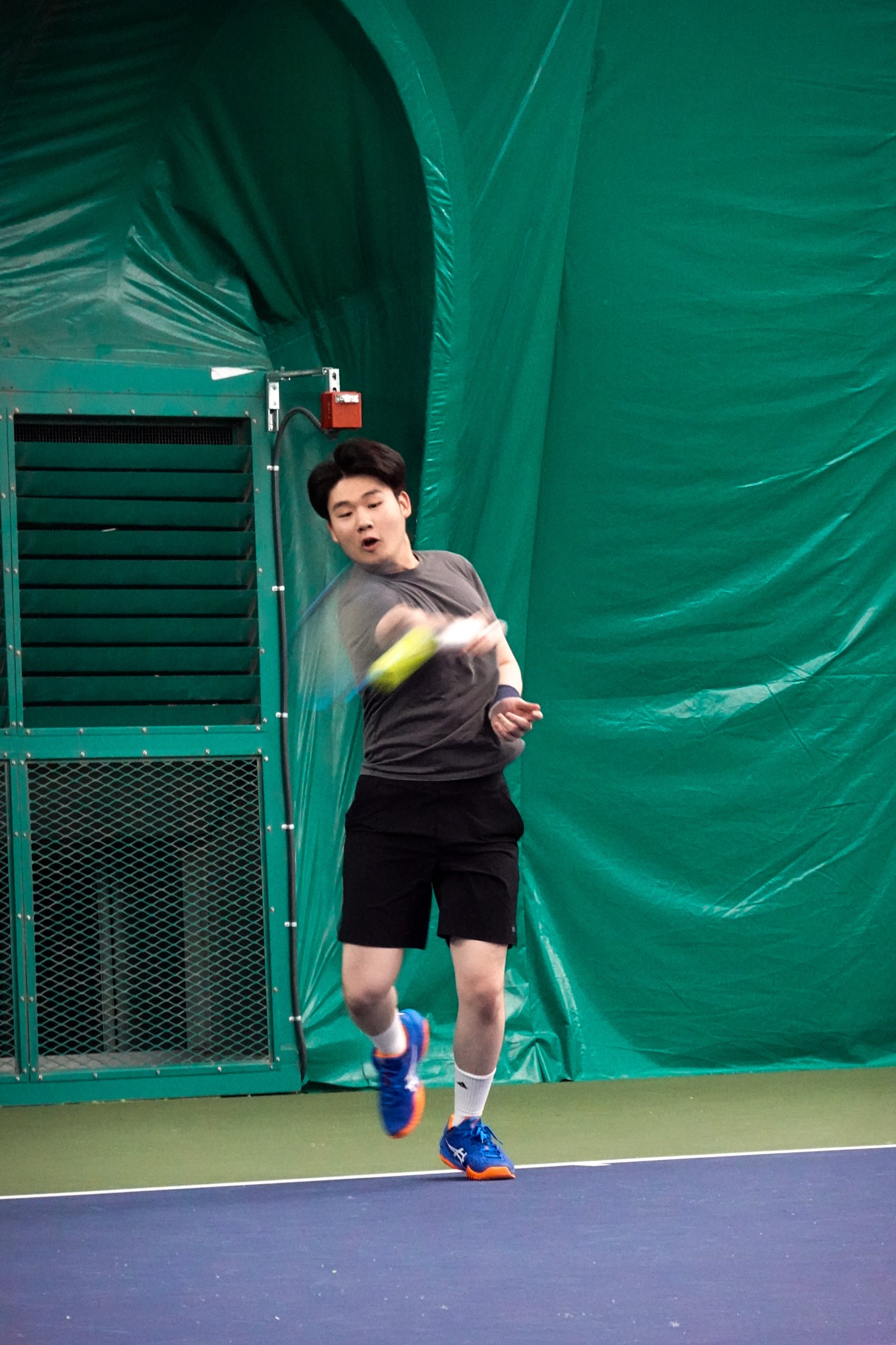 Joseph Chamdani playing tennis — forehand during match