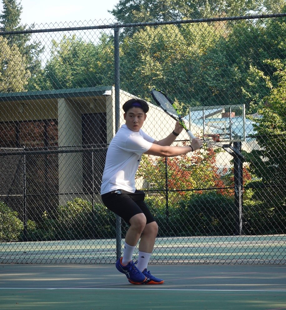 Joseph Chamdani playing tennis — one-handed backhand